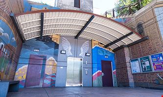 Cal State LA Station Elevator with murals decorating the corridor.