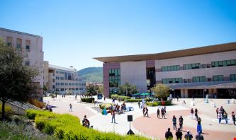 Wide-angle view of CSU Can Marcos' campus with students milling about.